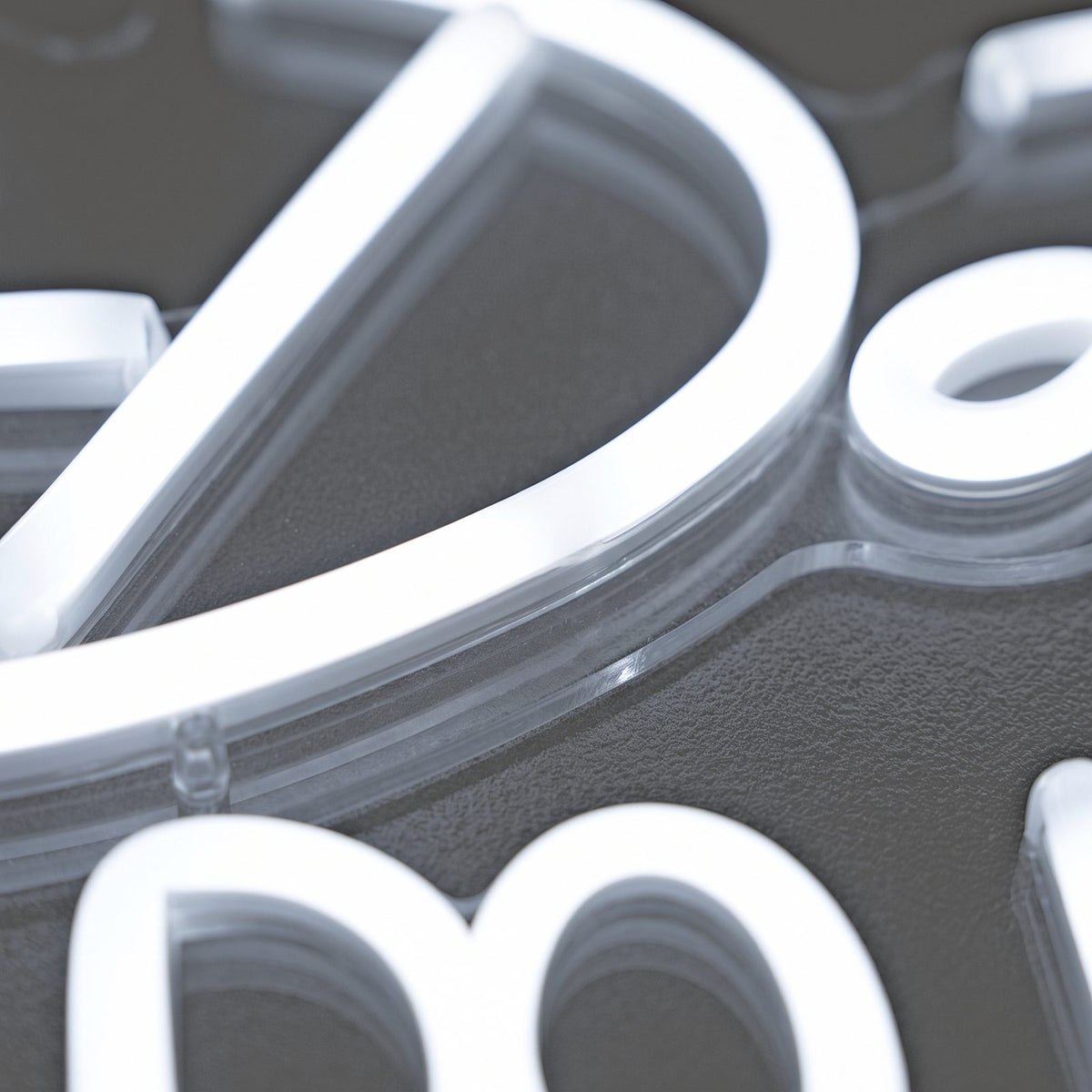 Close-up of glowing white neon LED lettering mounted on clear acrylic against a soft grey background, V360 Photobooths